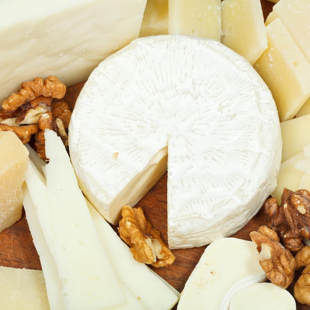 Assorted cheeses on wooden plate