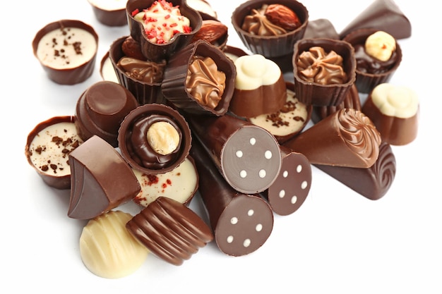 Assorted chocolate candies on white background