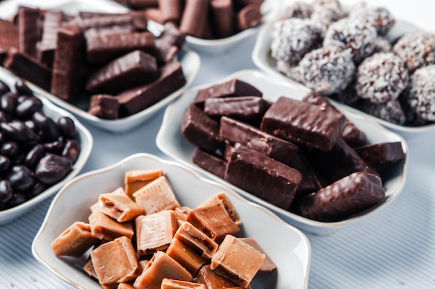 Assorted chocolate candies on wooden background