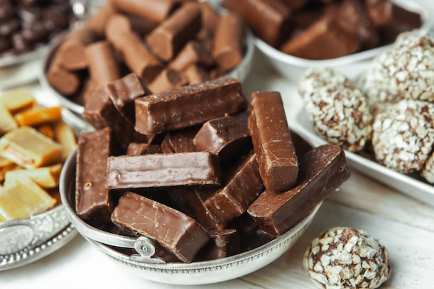 Assorted chocolate candies on wooden background