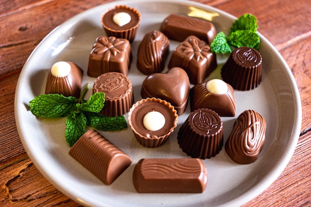 Assorted chocolates on a gray dish, milk chocolate, dark and white