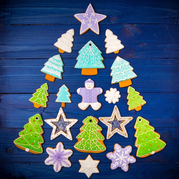 Assorted Christmas cookies in the shape of a Christmas tree on the blue