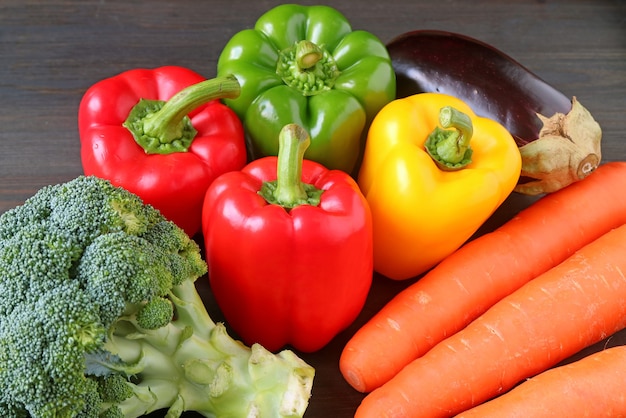 Assorted colorful fresh vegetables on a wooden table