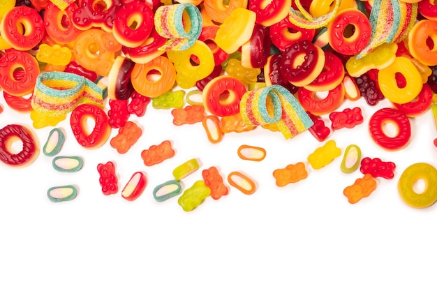 Assorted colorful gummy candies Top view Jelly donuts Jelly bears Isolated on a white background