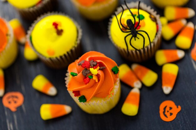 Assorted cupcakes with yellow and orange icing decorated for Autumn.