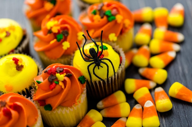 Assorted cupcakes with yellow and orange icing decorated for autumn