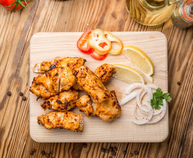 Assorted delicious grilled meat with vegetable on white plate 