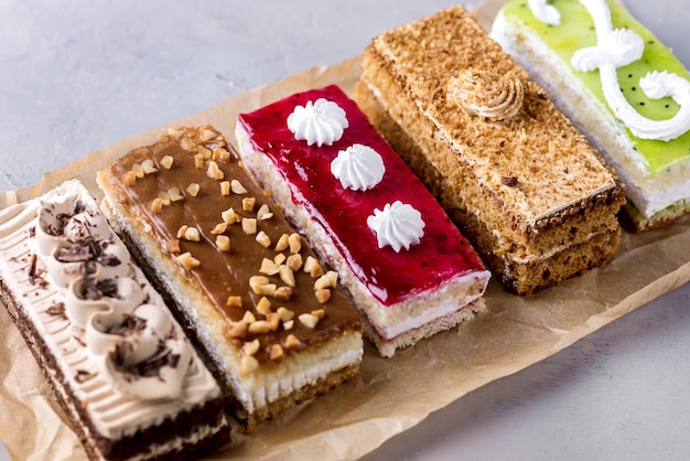 Assorted Different Mini Cakes with Cream Coffee Chocolate Salted Caramel and Berries Above