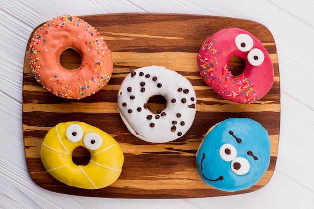 Assorted donuts on cutting board. Donuts of different flavors for breakfast.