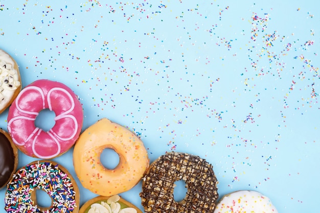 Assorted donuts with chocolate frosting, topping sprinkles donuts