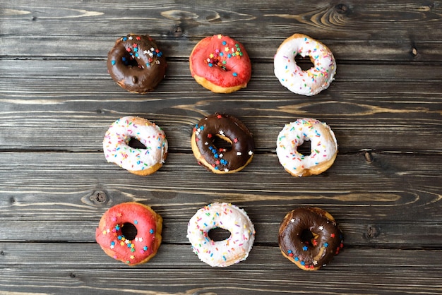 Photo assorted donuts on wood background top down layout copy space blank space