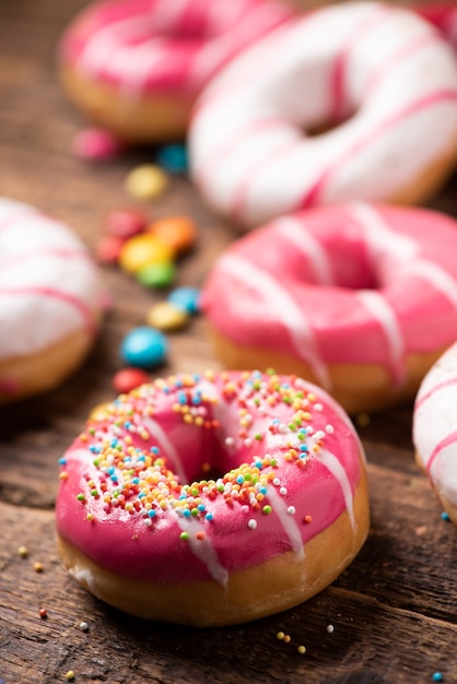 Assorted doughnuts on wooden table