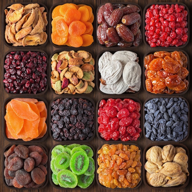 Photo assorted dried fruit background colorful mix food dates figs kiwi papaya cherry apricots prune raisins apples pears peach persimmon plums