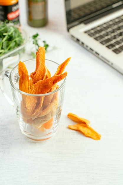 Assorted dried fruit in a glass. Healthy snack alternative while working at home