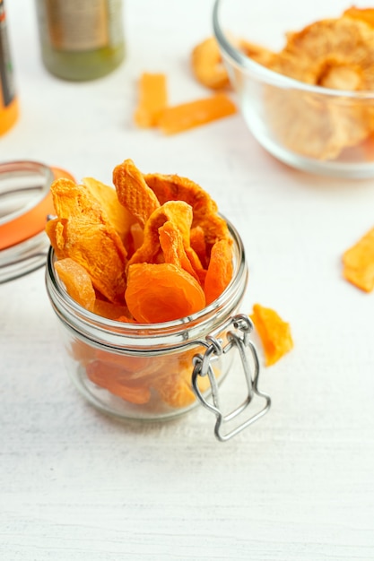 Assorted dried fruit, no sugar added, in a glass jar. Healthy snack alternative.