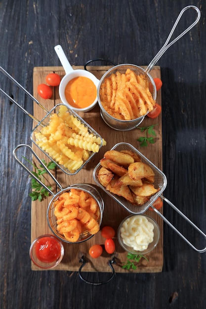 Assorted French Fries and Chips in Metal Baskets