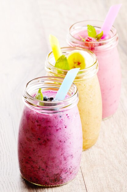 Assorted fruit shakes on white table