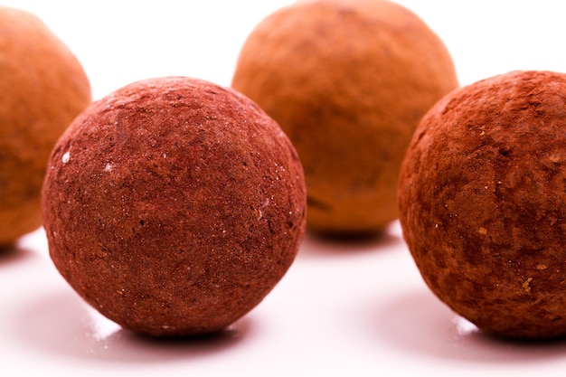 Assorted gourmet truffles on a white background.