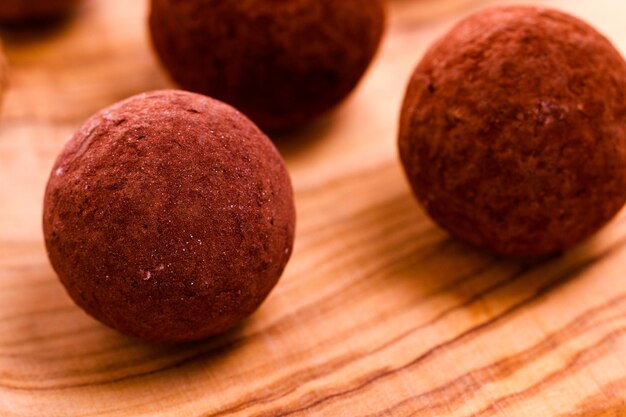 Assorted gourmet truffles on a wooden board.