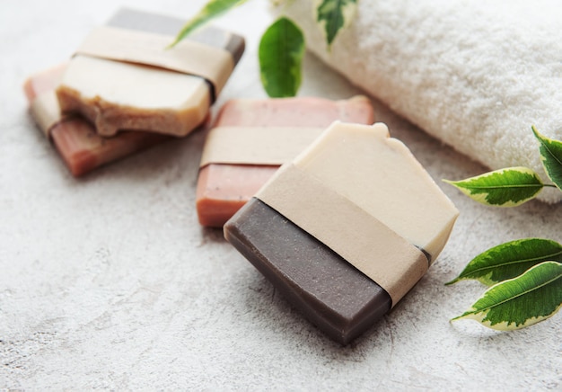 Assorted handmade soap bars and green leaves