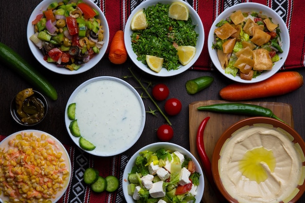 Assorted hummus raita fattoush mutabal quinoa salad snack served in dish isolated on table top view of arabic food