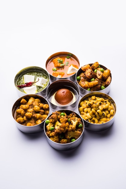 Assorted Indian Pakistani food in stainless steel bowls creating pattern or design, selective focus