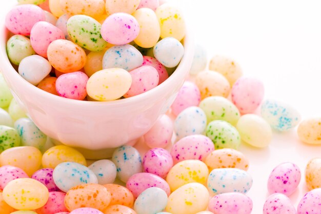 Assorted jelly beans in pastel colors with darker spots.