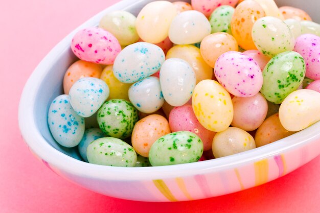 Assorted jelly beans in pastel colors with darker spots.