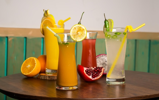 Assorted juices soda cumin seeds watermelon juice shake with Spicy Lemonade straw isolated on table