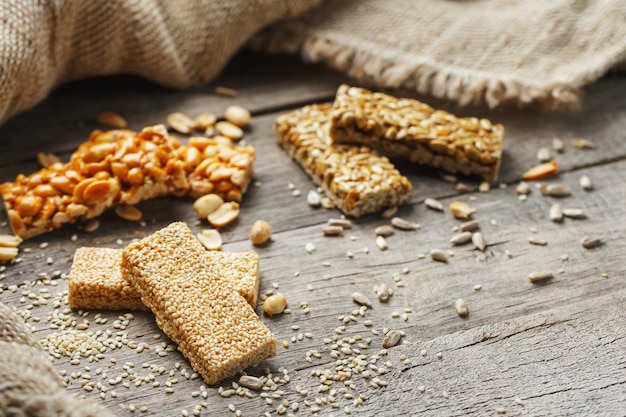 Assorted kozinaki,, with burlap fabric. Country style. Delicious sweets from the seeds of sunflower, sesame and peanuts, covered with shiny glaze.