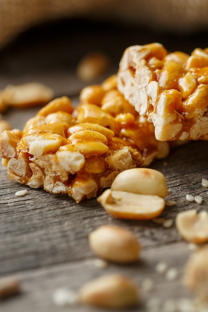 Assorted kozinaki, with burlap fabric. Country style. Delicious sweets from the seeds of sunflower, sesame and peanuts, covered with shiny glaze.