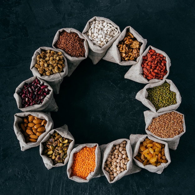 Assorted legumes and beans in sacks standing in circle