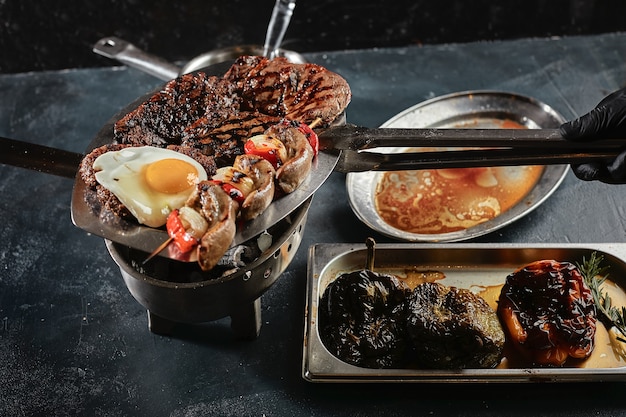 Assorted meat after cooking is laid out on a plate. Set for serving meat dishes. view from above.