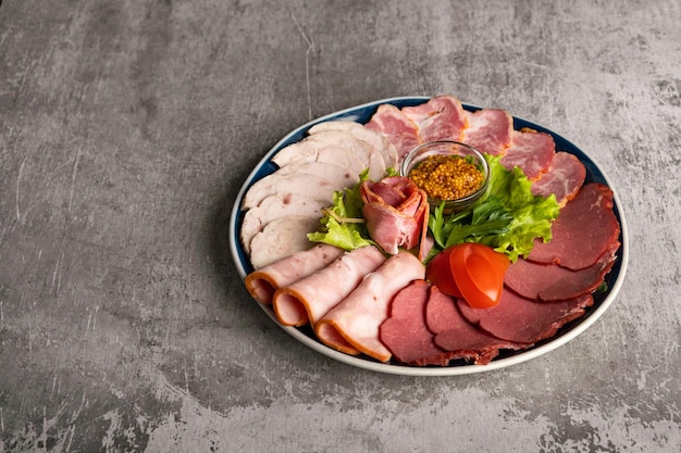 Assorted meat delicacies in a plate on the table