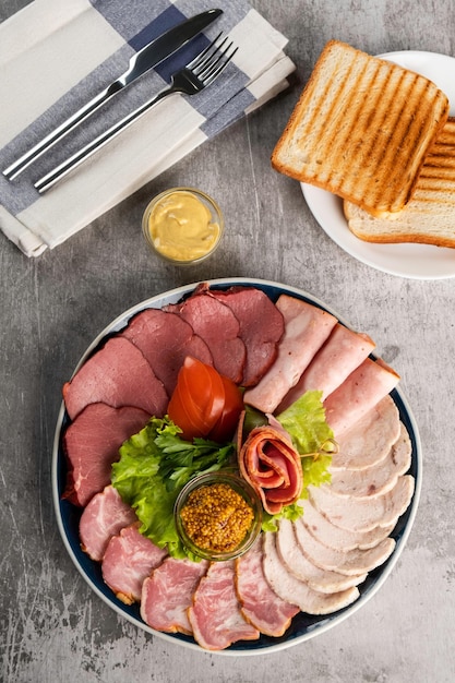 Assorted meat delicacies in a plate on the table