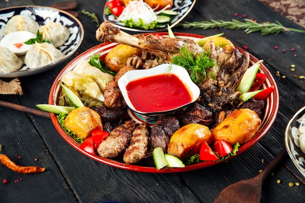 Assorted meat and potatoes on a traditional plate