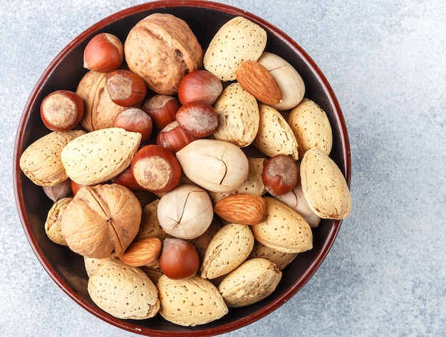 Assorted nuts in the peelalmonds hazelnuts pecans walnuts Gourmet snack Healthy food Selective focus