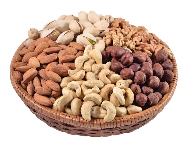 Assorted nuts in a wicker bowl isolated on a white background