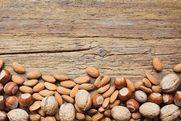 Assorted nuts in a wooden background