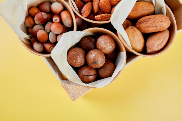 Assorted nuts in a wooden box nuts pecan almond macadamia brazil cashew hazelnut Rich in minerals and protein Healthy nutrition high in zinc magnesium and vitamins online ordering shoping concept