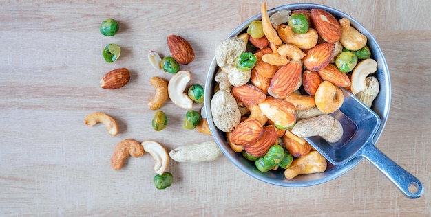 Photo assorted pea protein in a bowl with almonds green beans cashew nuts and peanuts vegan foodtop view