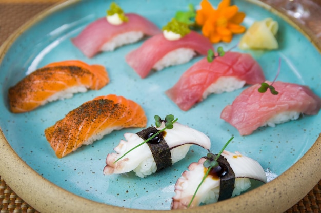 Assorted premium tuna and salmon nigiri sushi on a beautifully decorated plate