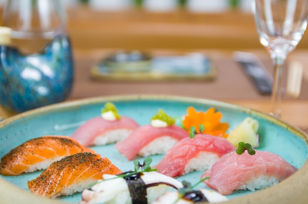 Assorted premium tuna and salmon nigiri sushi on a beautifully decorated plate