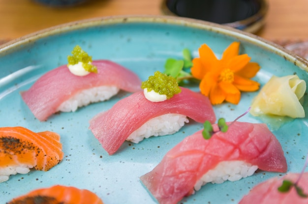 Assorted premium tuna and salmon nigiri sushi on a beautifully decorated plate