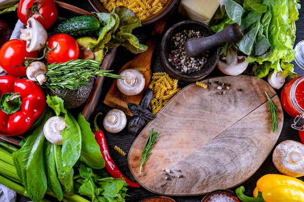 Assorted raw foods, vegetables and spices top view background