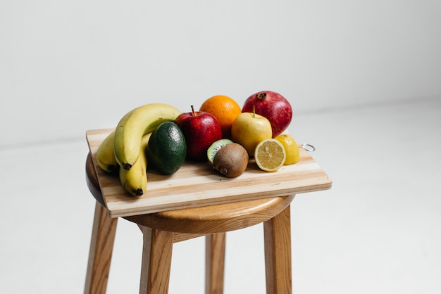 assorted ripe fruit on a wooden board . healthy diet