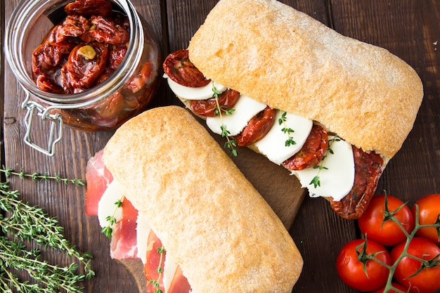 Assorted sandwiches. sandwich Caprese with mozzarella and sun-dried tomatoes and ciabatta with ham
