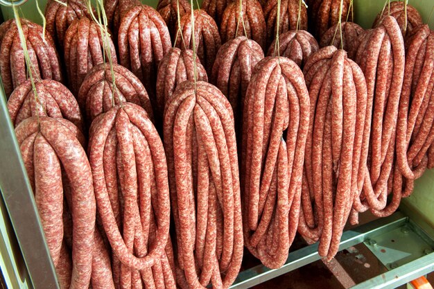 Assorted sausages hanging in a butchery