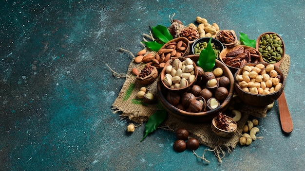 Assorted shelled nuts walnuts cashews hazelnuts Brazil nuts almonds Close up macro Assortment of shelled nuts Side view on the texture table