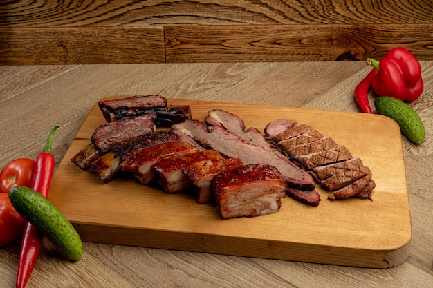 Assorted smoked meats served on a wooden tray